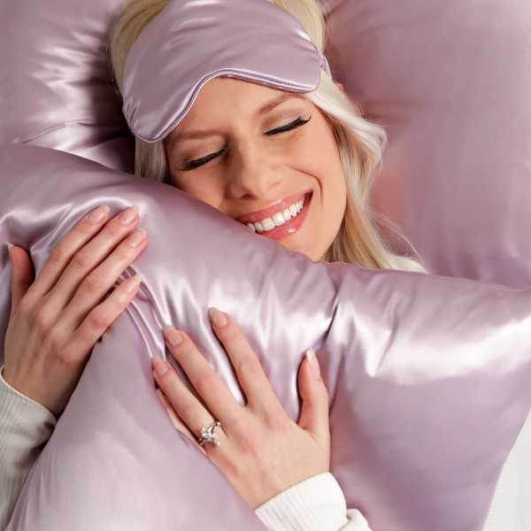 woman holding silk pillowcase against skin